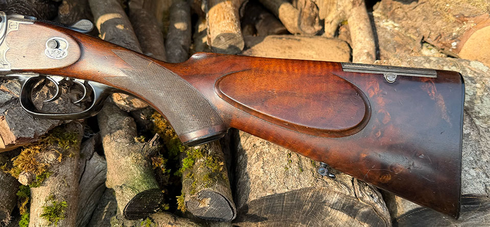 Pistol grip stock with cheek-piece and bullet trap.