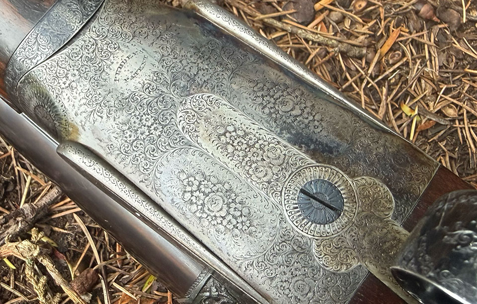 Full coverage rose bouquets and fine scroll epitomise the subtle class and style of guns made for the British nobility.