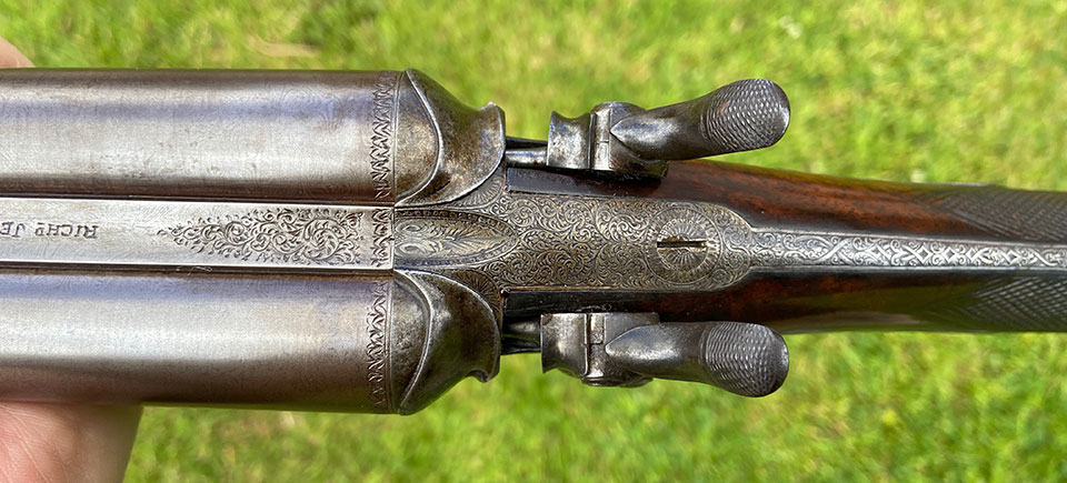 The gun at half-cock, showing strikers attached to hammer noses.