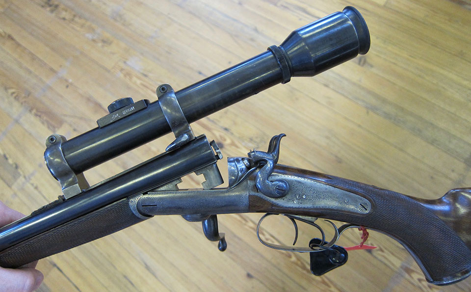 A .303 hammer rifle with telescopic sight.