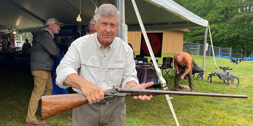 The show is a good place to buy and sell. Mike Hinnenkamp with a nice bar action hammer gun.