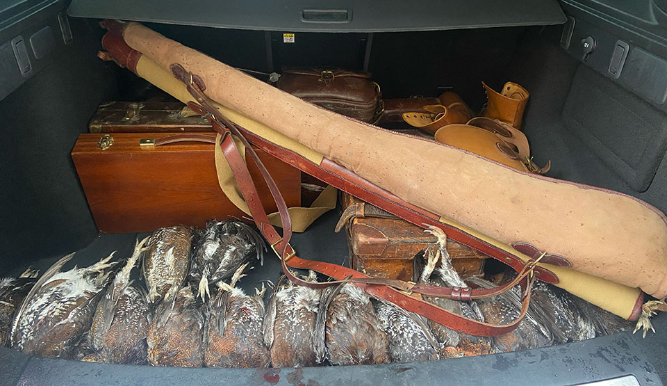 The boot packed with guns, ammo and grouse.
