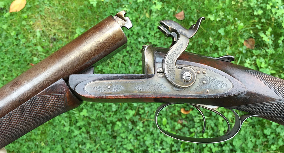 Early Westley Richards breech-loaders, like this pinfire, had the bolted dolls-head as the sole means by which the barrels were secured to the action. This one is a very unusual, early version, with a slide-back top lever.