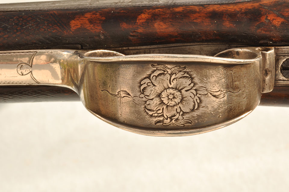 A rose engraved on the silver trigger guard, this on a weapon of war !